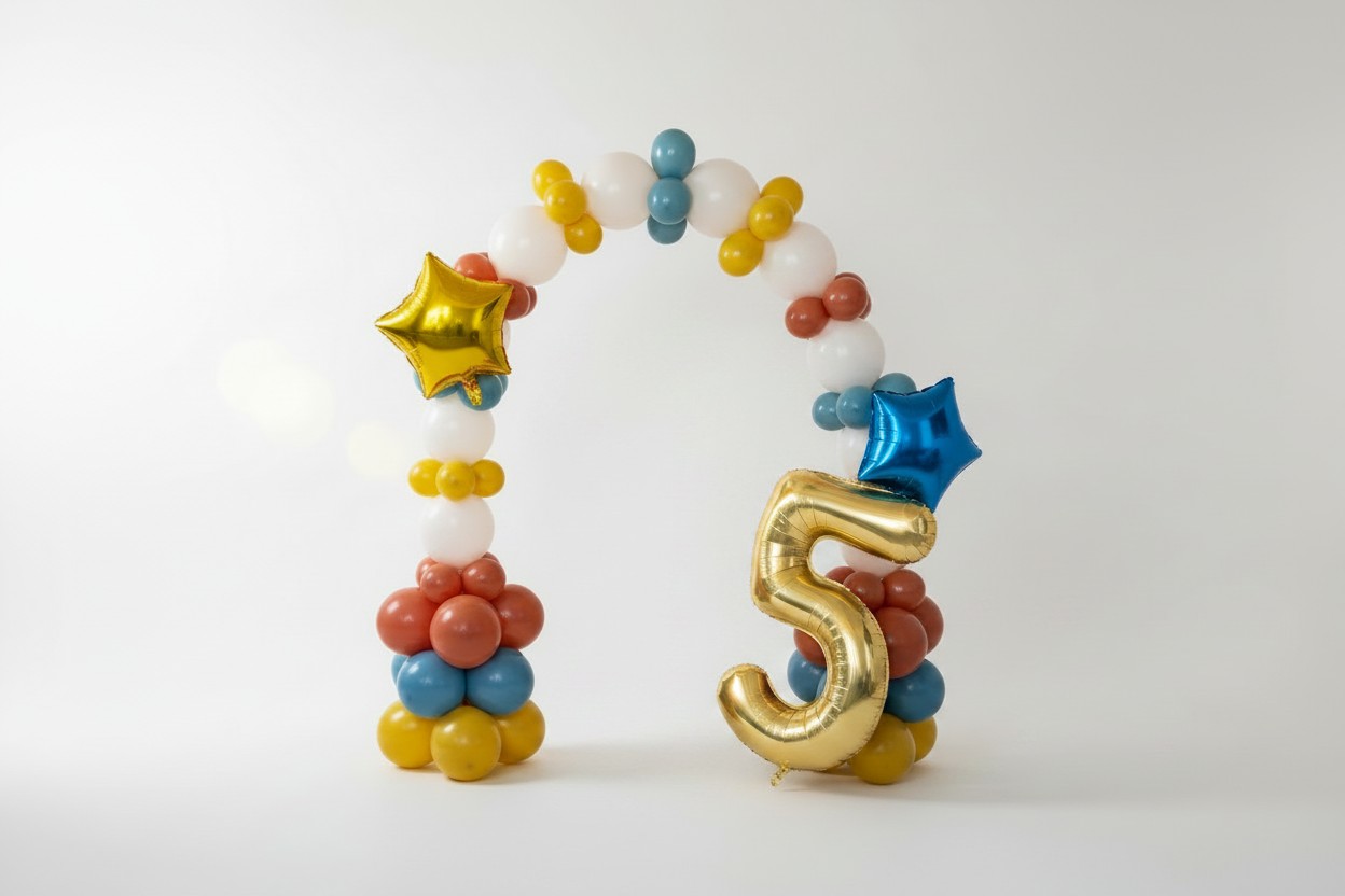 Freestanding balloon arch in white, gold, teal and terracotta with a gold foil number 5